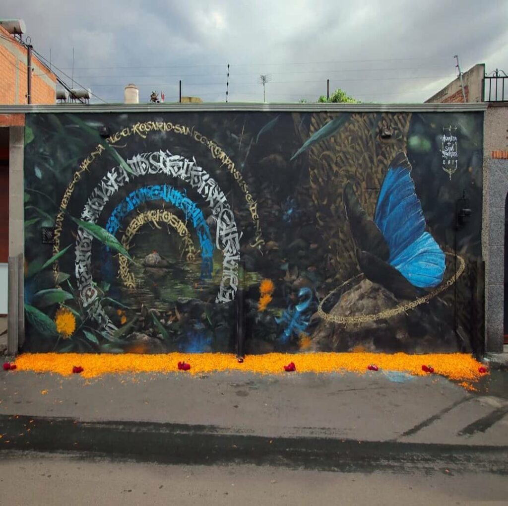 Ofrenda del los Animeros, San Juan de Tihuaca, Mexico | Butterfly mural by street artist Mantra